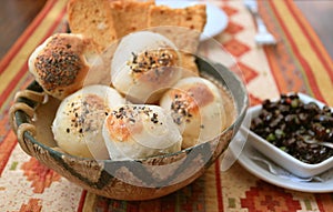 Argentinian Sesame Table Rolls in a Wooden Basket with Black Beans Dip