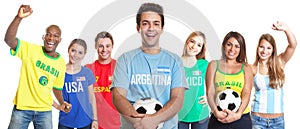 Argentinian soccer fan with ball and other fans