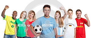 Argentinian soccer supporter with ball and fans from other count