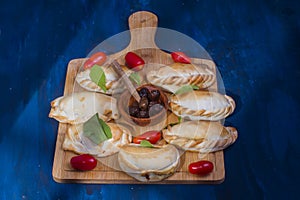 Argentinian traditional food in a wooden table.Empanadas Argentinas