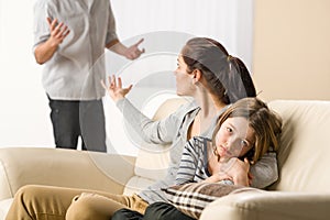Arguing parents with sad little girl