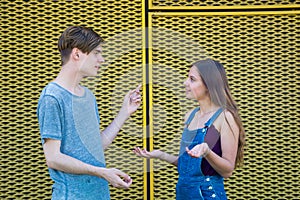 Arguing teenagers gesticulating with question