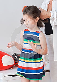 argumentative young girl is playing dress up with grandmother