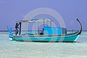 Ari Atoll, Maldives: A maldivian sailor is fishing on his boat
