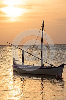 Ari atoll Maldives sunset with boat in Silhouette