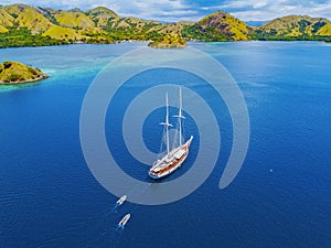 Arial view of beautiful scenery at Flores island with tourist yatch, turqouise and dark blue sea photo