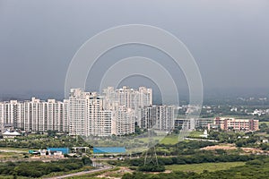 Arial view Cityscape in Gurgaon, Noida, Jaipur, Delhi NCR, Lucknow, Mumbai, Bangalore, Hyderabad showing small houses sky scrapers