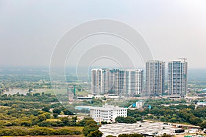 Arial view Cityscape in Gurgaon, Noida, Jaipur, Delhi NCR, Lucknow, Mumbai, Bangalore, Hyderabad showing small houses sky scrapers