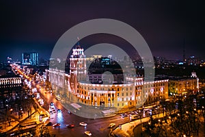 Arial view of famous Voronezh building with tower in night, symbol of Voronezh and evening cityscape with rads, parks and traffic