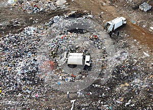 Arial view of garbage truck during unloading the rubbish and food waste. Recycling garbage. Work at landfill. Waste conservation.