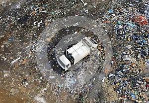 Arial view of garbage truck during unloading the rubbish and food waste. Recycling garbage. Work at landfill. Waste conservation.