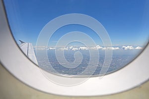 Arial view from jetplane blue sky and big white cloud with green island background,out of focus