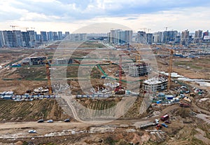 Arial view of a large construction site. Tower cranes in action. Housing renovation concept. Crane during formworks. Construction