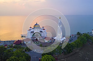 Arial view of Majestic Malacca Straits Mosque during sunset.