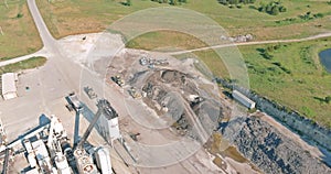 Arial view of the open pit mine gravel into stone crusher in heavy mining machinery equipment for earthworks