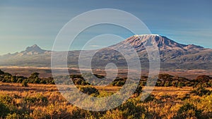 Arid dry African savanna in late evening with Mount Kilimanjaro