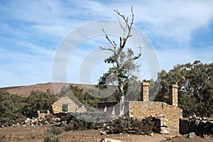 Arid landscape with abandoned settlement in foreground