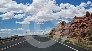 Arid landscape of Arizona. The crumbling sandstone mountains and the highway