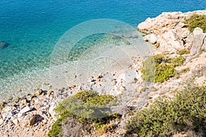 The arid rocky coast and its green countryside along small beaches, in Europe, Greece, Peloponnese, Argolis, Nafplio, Myrto