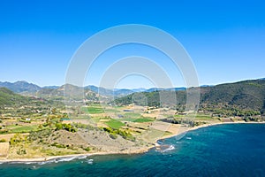 The arid rocky coast and its green countryside, in Europe, in Greece, in Aetolia Acarnania, towards Patras, by the Ionian Sea, in