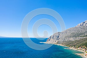 The arid rocky coast and its green countryside, in Europe, in Greece, in Aetolia Acarnania, towards Patras, by the Ionian Sea, in