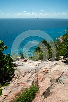 Aride island nature reserve view from the Indian Ocean with blue sky.