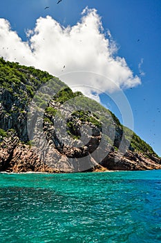 Tropical island coastline in the ocean with blue sky