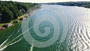 An Ariel dolly of 2 boats in a head on POV with wakes spreading and crossing behind them on a recreational Reservoir Lake