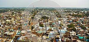 Ariel panorama shot of a city with large number of small houses with greenery around it