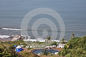 Ariel shot of a villa with swimming pool near the beach in goa