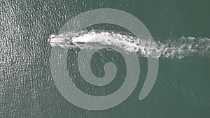 Ariel view of coast guard powerboat cruising in high speed. Speedboat border guard patrol the sea.