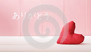 Arigato - Thank you in Japanese language with a red heart cushion photo
