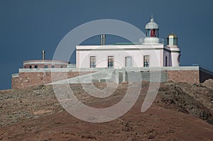 Arinaga lighthouse on a hill.