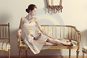 Aristocratic girl on sofa