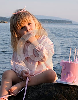 Aristocratic little girl having picnic on the seashore