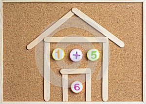 Arithmetic Toy Numbers on cork board.