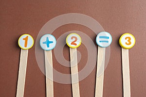 Arithmetic Toy Numbers on cork board.