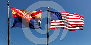 Arizona and US Flag fly in a blue sky