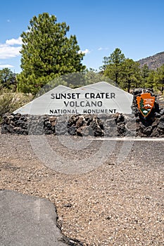 Welcome sign for Sunset Crater Volcano National Monument on a sunny day