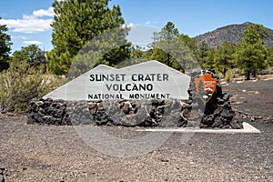 Welcome sign for Sunset Crater Volcano National Monument on a sunny day