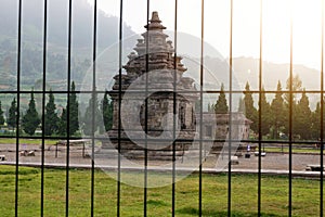 Arjuna and Semar temples behind a black metal gate