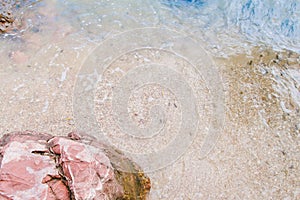 Arkose pink stone , sand and seawater