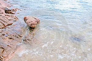 Arkose pink stone , sand and seawater photo
