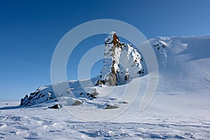 Arktic Chukotka. Cliffs protruding from the snow.