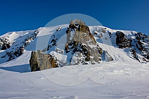 Arktic . Cliffs protruding from the snow.