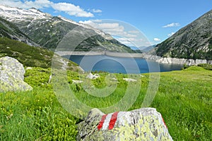 Arlhoehe - A path mark on a lush green meadow in Alps photo