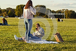 Two young woman are relaxing in Gravelly Point park at a sunny afternoon.