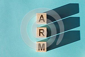 ARM - acronym from wooden blocks with letters, Advanced RISC Machine ARM concept chip architectures microprocessor technology, top