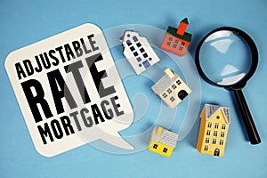 ARM Adjustable-Rate Mortgage text with house models on blue background