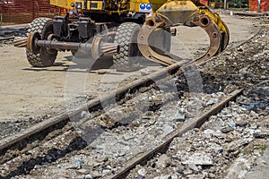 Arm and claw of an excavator resemble tram tracks 3